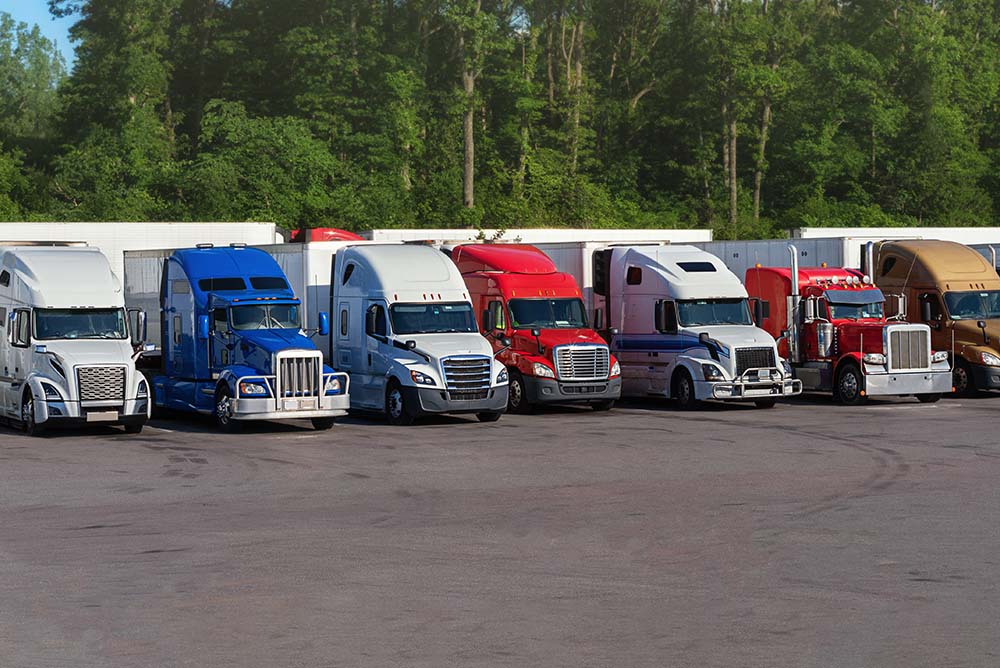 Fleet of American semi trucks parked in secure facility